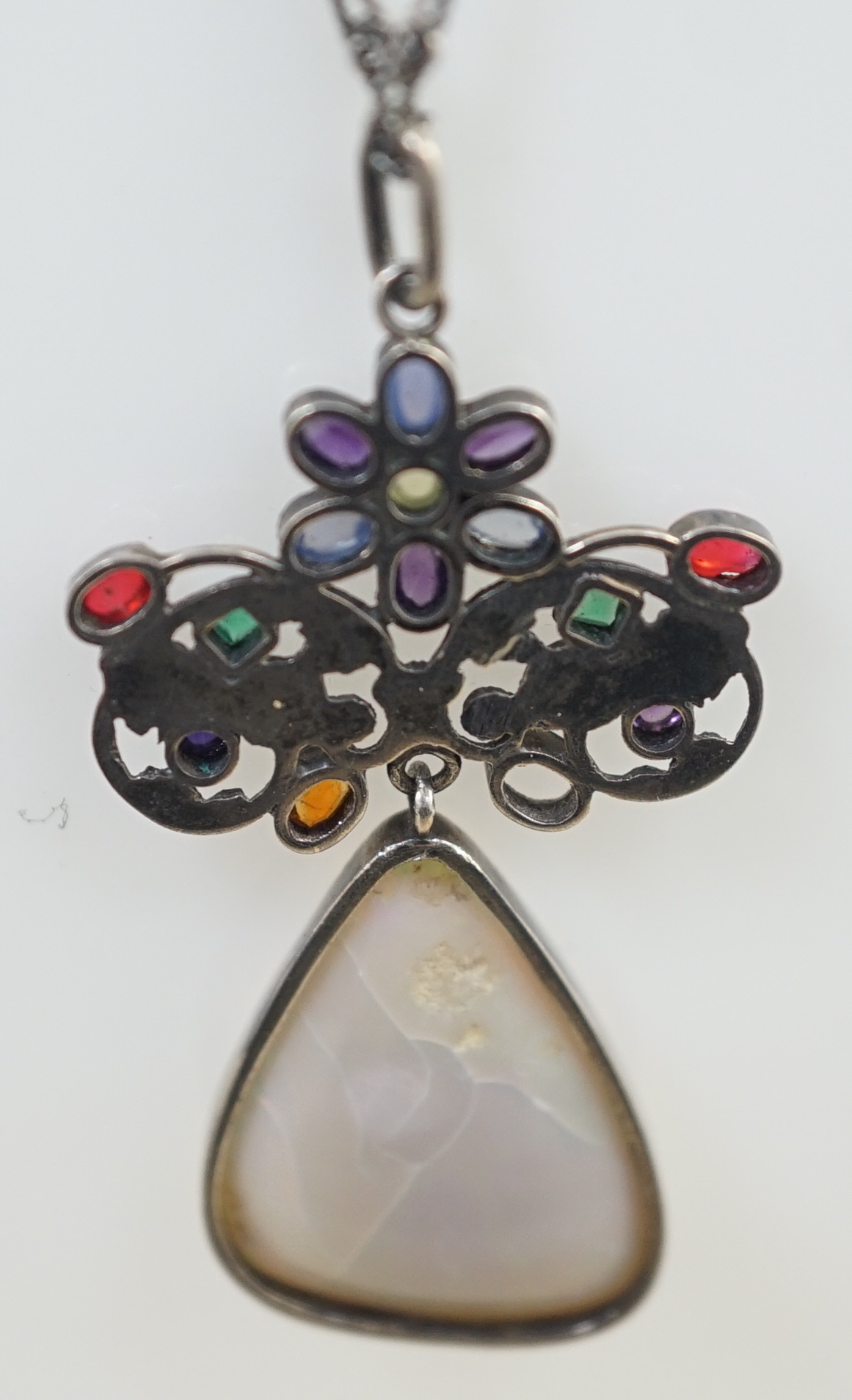 An early 20th century silver, white opal and cabochon gem cluster set drop pendant necklace, in the manner of Sibyl Dunlop